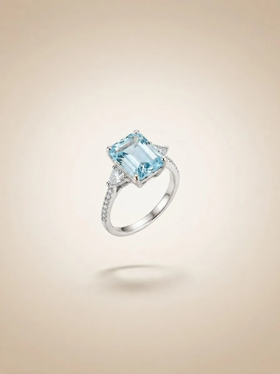 Aquamarine and diamond ring suspended against a warm backdrop