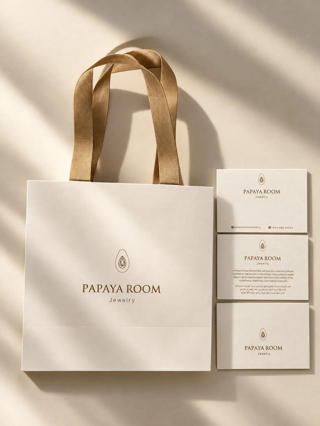 Papaya Room gift bag beside three branded cards