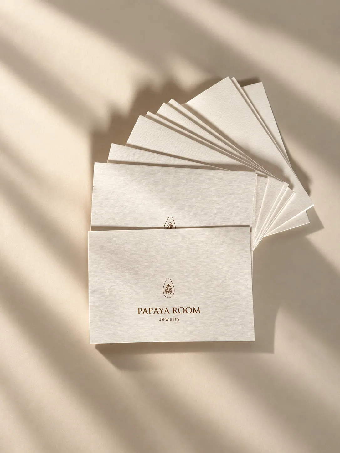 Fanned Papaya Room envelopes in sunlight